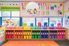 a brightly colored classroom with lots of colorful bins and toys on the shelves in front of windows