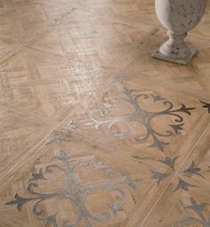 a wooden floor with silver and black designs on it