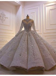 a white wedding dress on display in a room