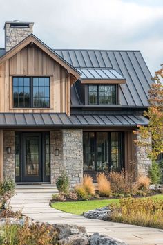 a large house with stone and metal roofing