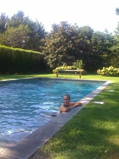 a woman sitting in the middle of a swimming pool