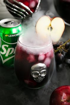 an apple and soda drink sitting on top of a table