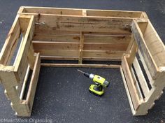 a wooden box with tools in it sitting on the ground next to some wood pallets