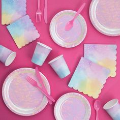 pink and white paper plates, napkins, forks and utensils on a pink background