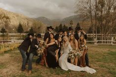 a group of people that are standing in the grass