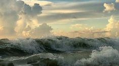 an ocean with waves and clouds in the sky