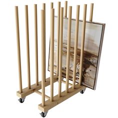 a wooden rack with two pictures on it's sides and four wheels attached to each other