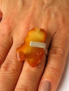 A beautiful ring from Baltic amber, polished, modern, connected with matte silver 925.  Size of the Amber:  approx.  1,42" x 0,94" Colour:  white, yellow Weight: 4g The ring is adjustable. Beautiful unique amber ring. This silver sterling ring with natural amber is out of time, it is perfect for any occasion. All listed items are custom-made jewellery and unique pieces. Nice detail to any outfit. Offered is the ring illustrated Ring arrives in a gift box Sending  as a gift  with airmail and trac Out Of Time, Amber Ring, Natural Amber, Amber Necklace, Amber Stone, Amber Jewelry, Platinum Ring, Silver Sterling, Beautiful Ring