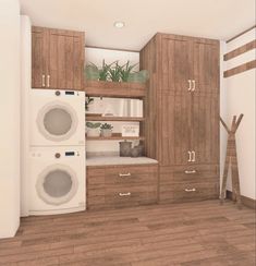 a washer and dryer in a room with wood flooring, built - in cabinets