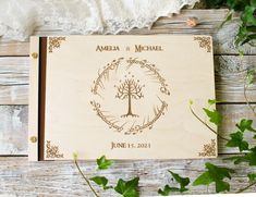 a wooden wedding guest book with a tree on it