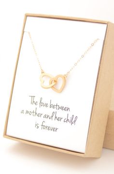 the love between a mother and her child is forever necklace in gold on a card