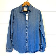 A Super Cute Brand New Abercrombie & Fitch “Boyfriend Fit” Blue Button Down. A Great, Perfect For Fall Item! Original Price: $65. Size Extra Small! Measurements Bust (Pit To Pit): 19 Inches Sleeves: 23 1/2 Inches Length (Shoulder To Hem): 25 Inches **All Measurements Are Approximate & Made When Laid Flat Comes From A Smoke-Free, Fragrance-Free & Pet-Free Home. Bundle & Save Offers Always Welcome!! Chambray Button-up Shirt With Buttons, Blue Button-up Everyday Flannel Shirt, Affordable Chambray Button-up Tops, Medium Wash Chambray Button-up Blouse, Medium Wash Chambray Button-up Shirt, Fall Items, Boyfriend Fit, Abercrombie Fitch, Fragrance Free Products