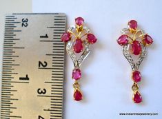 14k GOLD EARRINGS EAR STUD FROM RAJASTHAN INDIA, GREAT HANDMADE DESIGN MADE OF 14K YELLOW GOLD SATED REAL A QUALITY RUBY & DIAMOND GEM STONES, NICE PIECE GOOD FOR JEWELRY COLLECTION.Height max. - 2.8 cm(1.1")width max. - 1.2 cm(0.47")Total weight - 3 gramsMaterial - 14 carat solid yellow gold & real gem stones. Gold Ruby Earrings With Diamond Accents, Traditional 17 Jewel Diamond Earrings For Gift, Yellow Gold Ruby Earrings With Diamond Accents, Traditional Diamond Earrings With Gemstone, Gold Earrings With Gemstone And American Diamond, Traditional 17 Jewel Diamond Earrings For Anniversary, Traditional Red Diamond Earrings, Ruby Earrings For Anniversary And Festive Occasions, Festive Ruby Earrings For Anniversary