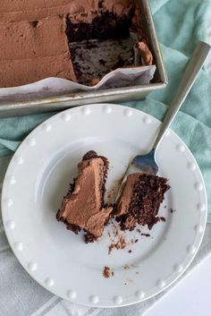 a piece of chocolate cake on a plate with a fork