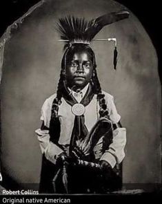 an old black and white photo of a native american man