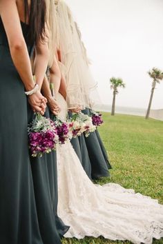 the bridesmaids are holding their bouquets together