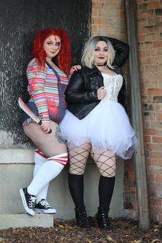 two women dressed in costumes posing for the camera