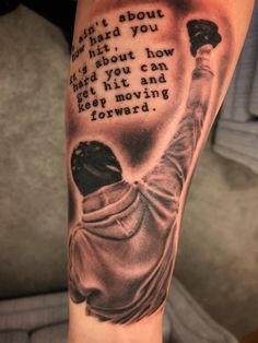 a man's arm with a quote on it