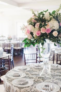 a vase filled with pink and white flowers on top of a table