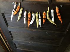 an assortment of fake toothpicks hanging from a string on a wooden door frame