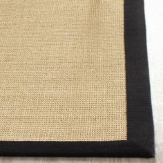 a black and beige area rug on the floor