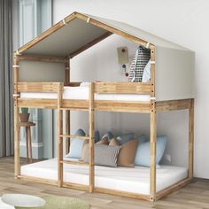 a wooden bunk bed with white mattresses and blue pillows