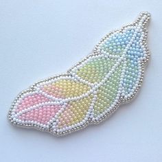 a beaded brooch with an image of a butterfly on it's side