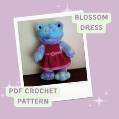 a crocheted stuffed animal in a dress with the words blossom dress on it