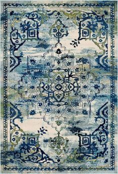 a blue and green rug with an ornate design