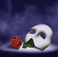 a white mask with a red rose sitting on top of it in front of a dark blue background