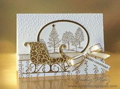 a card with a horse drawn sleigh on the front and gold trimmings