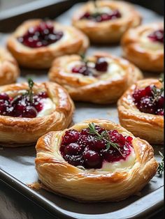 small pastries with cranberry sauce and herbs on top