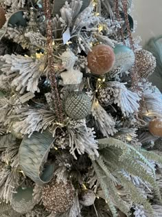 a christmas tree decorated with silver and gold ornaments