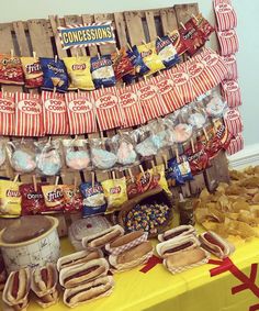 an assortment of hot dogs and corn chips on a table