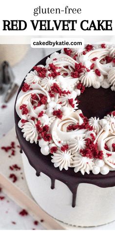 a red velvet cake with white frosting and sprinkles on the top