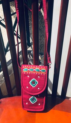 This is a beautiful hand-embroidered bag with green, white and yellow embroidery on a beautiful maroon base. There are beautiful small white beads stitched throughout the front and the back of the case.  The bag is approximately 6.8 inches (17.27 cm) in height and 3.6 inches (9.14 cm) wide. The length of the sling is about 24 inches (61 cm)  perfect to hang on your shoulder or as a crossbody bag.  This is a perfect size as a small purse for your phone or small wallet. Perfect as a present for yo Phone Sling Bag, Yellow Embroidery, Beautiful Pen, Bead Stitching, Embroidered Bag, Small Purse, Small Wallet, White Beads, Sling Bag