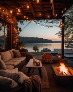 a living room with couches, tables and lights on the ceiling over an outdoor fire pit