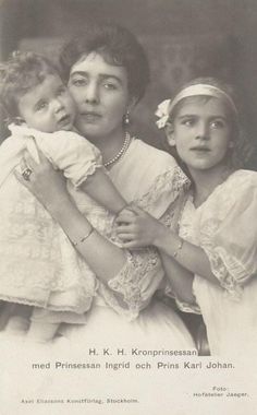 an old black and white photo of two women holding a baby in her arms, with the caption