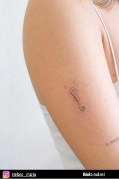 a woman with a small tattoo on her arm