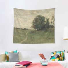 a living room with a couch, table and wall tapestry hanging on it's wall