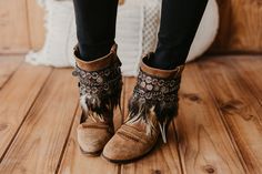 Elevate your boot game with our Tribal Boot Covers featuring embroidered feathers and coin wrap. Handcrafted with care, these ethnic accents bring a touch of bohemian style to your footwear. The unique combination of tribal patterns and delicate feathers creates a fashion statement that sets you apart. Embrace the artisanal charm and showcase your free-spirited personality with these distinctive Tribal Boot Covers.  SPECIFICATIONS * Made of a synthetic leather base  * Embroidered trimmings in ne Embroidered Feathers, Boot Covers, Boho Leather, Boot Cuffs, Diy Shoes, Free Spirited, Boho Stil, Brown Suede, Synthetic Leather