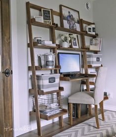 a computer desk with shelves and pictures on the wall