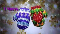 two knitted mittens hanging from strings with snowflakes in the background