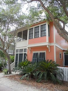 an orange and white house surrounded by trees