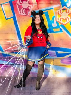 a woman is posing in front of a graffiti wall