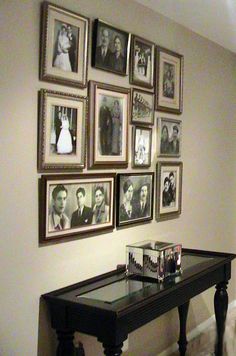 a black table sitting in front of a wall with pictures on it's side