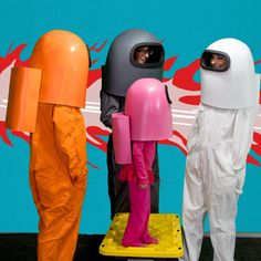 three mannequins dressed in white and orange standing next to each other