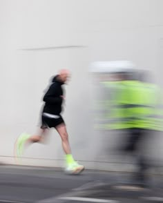 a blurry photo of a man running down the street