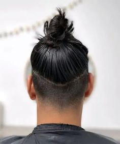 Glossy High Bun with Undercut. This trendy men’s hairstyle can be a cool choice for anyone wanting a fashionable aesthetic with modern edge. Man Bun Undercut Fade, Bun With Undercut, Mens Long Hair Undercut, Top Knot Hairstyle, Man Bun Top Knot, Top Knot Men, Man Bun Undercut, Knot Hairstyle