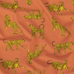 an orange and yellow fabric with leopards on it